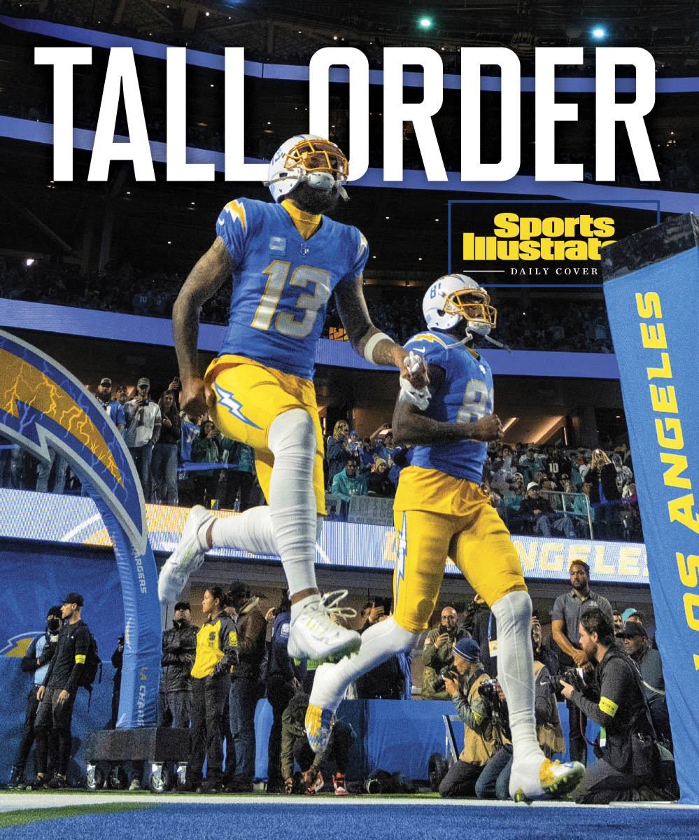 Chargers players run onto the field with the heading TALL ORDER
